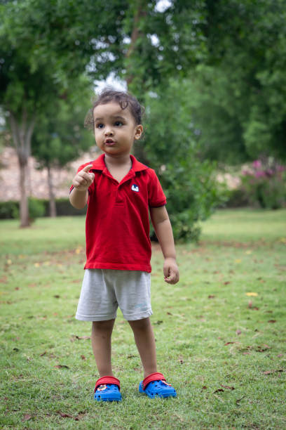 istock isolated indian kid walking at outdoor park at evening from flat angle 2168148678