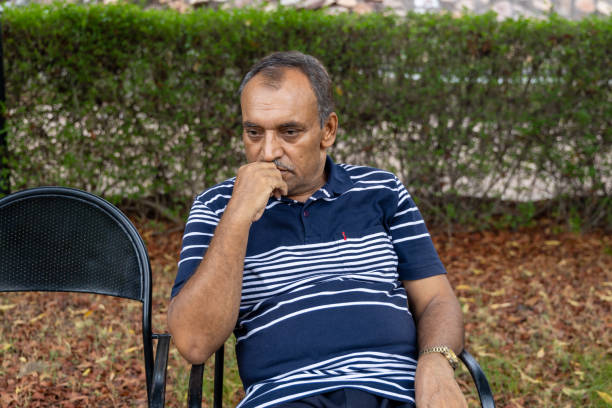 istock isolated alone man in depression sitting at outdoor park at evening from flat angle 2168149289