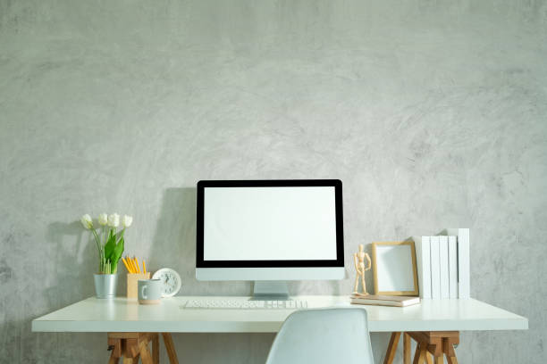 istock Comfortable workplace with blank computer screen, picture frame, houseplant and stationery. 2168149733