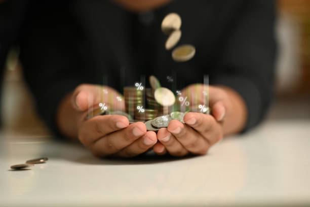 istock Several coins falling into hands with percentages and bar graphs. Interest rates, financial growth, or investment returns concept 2168155855