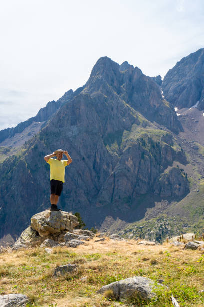 istock man hiker standing rock enjoy landscape mountains pirineos 2168157666