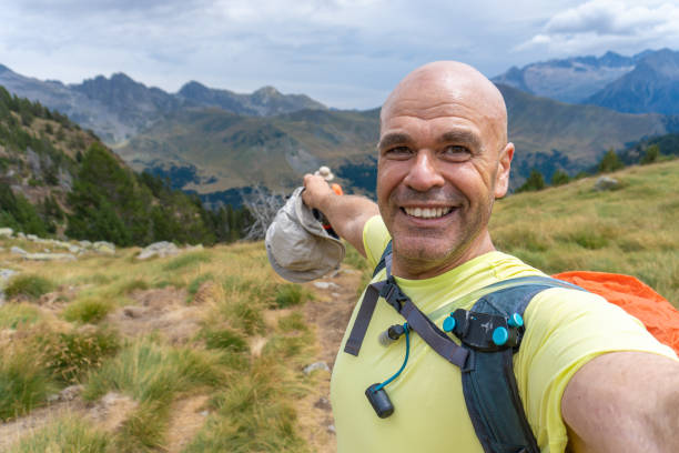 istock Smiling man hiking on mountains, photo selfie 2168157824