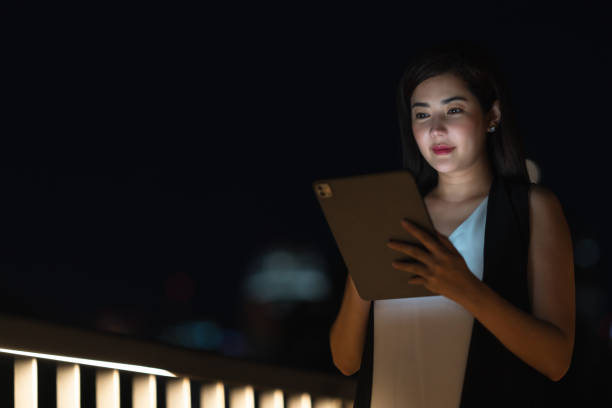 istock Woman Enjoying Smartphone in Urban Evening Light 2168160542
