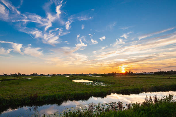 Tranquil view of a sunset sky over the Dutch polder landscape near Gouda, The Netherlands.