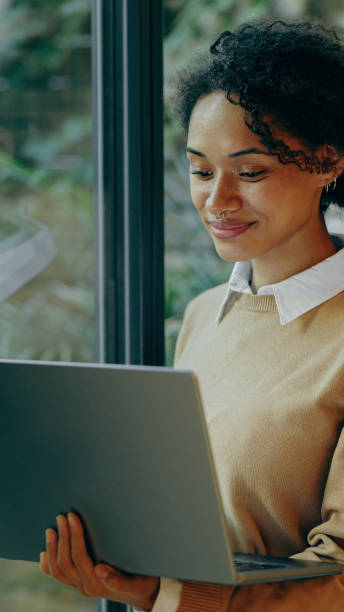 istock A Woman Engaged with a Laptop While Seated in a Cozy and Comfortable Environment 2168164556