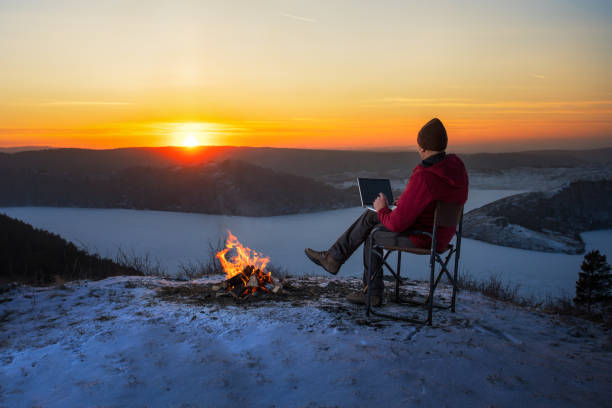 istock Ma Using Laptop On Camping In Winter  Nature. 2168168251