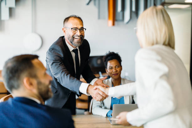 Colleagues seal deal with a handshake