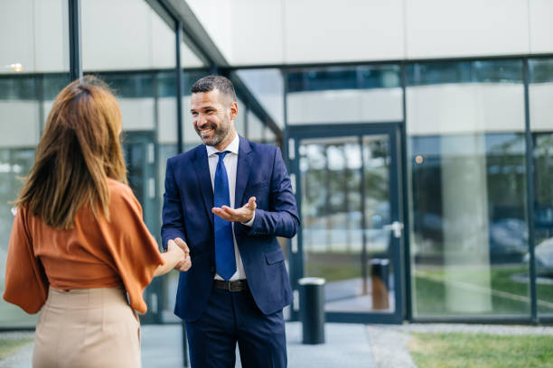istock Handshake between businesswoman and businessman 2168174624