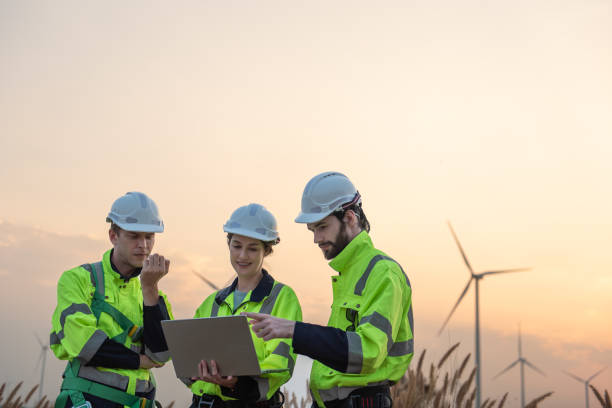istock Engineers working and using tablet on site in wind turbine farm, Wind turbines generate clean energy source, Eco technology for electric 2168175231