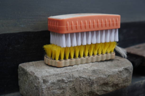 Close-up of a versatile scrub brush featuring both stiff and soft bristles for various cleaning tasks. The ergonomic handle ensures comfortable use.