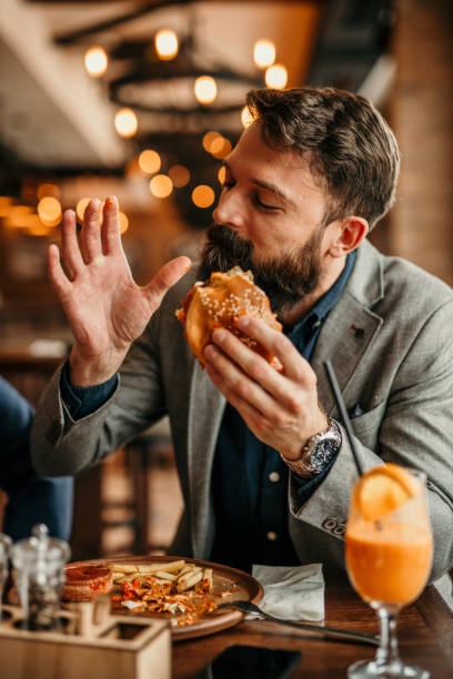 Businessman grabbing a burger
