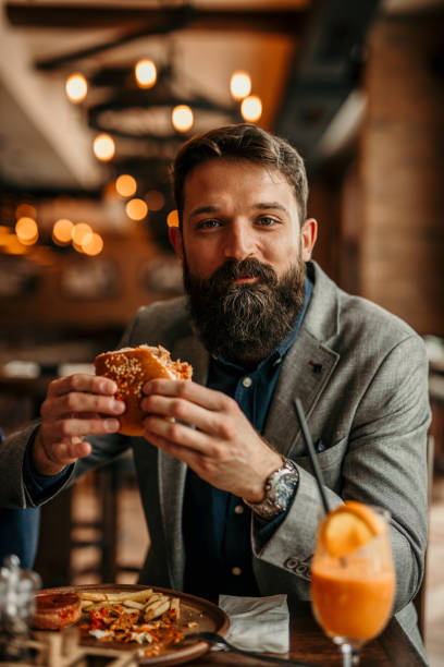 istock Businessman grabbing a burger 2168185939