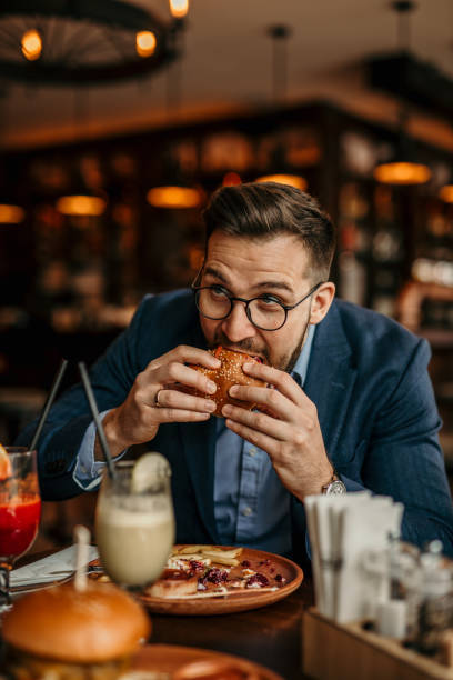 istock Businessman grabbing a burger 2168185981
