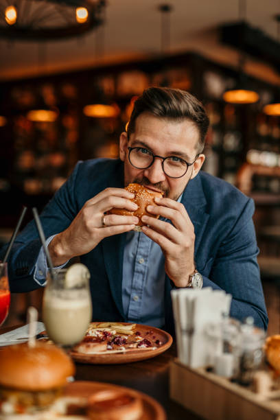 istock Businessman grabbing a burger 2168185982