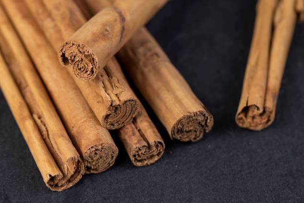 istock Thick wooden cinnamon on a black slate board 2168186791