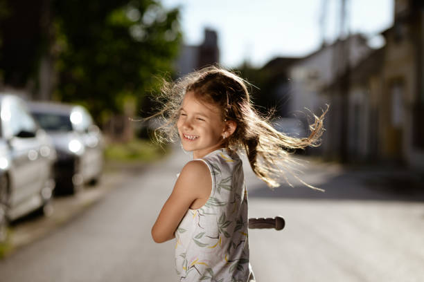 Beautiful girl having fun on a push scooter.
