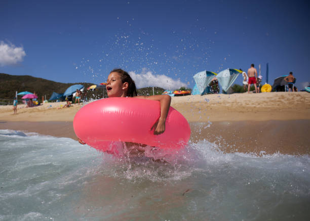 Beautiful girl enjoying summer vacation swimming in sea.