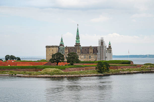Lyngby, Denmark - June 20, 2013:People enjoying the late evening nordic sun the day before summer solstice in front of the newly restored  Eremitage Castle in Dyrehaven - the Deer park - north of Copenhagen.