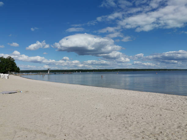 istock Sandy beach with blue sky and white clouds on a sunny summer day 2168194604