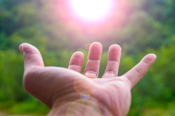 istock Hand reaching out a shining light representing blessing. Ideas for copy space for inspirational messages 2168197671