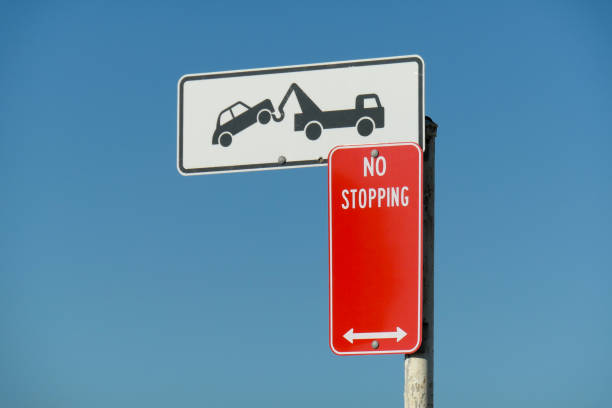 No Stopping and Tow Away Zone signs on the road approaching the international terminal of Sydney Kingsford-Smith Airport. This image was taken on a hot and sunny afternoon on 24 August 2024.