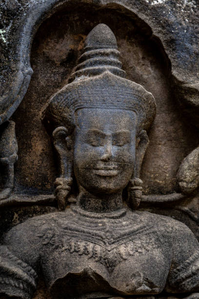 Shot in color detail on the facade of this historic building representing some character, animal or flower. Set at Siem Reap, Angkor Wat , Cambodia, Asia