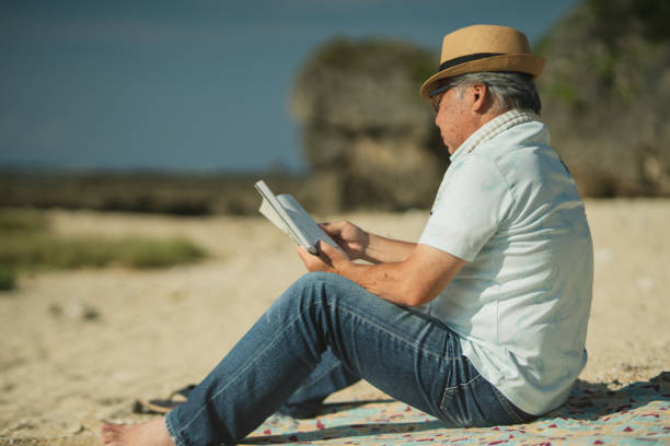 istock Senior men past retirement age relax and enjoy their hobbies on a sandy beach. 2168207555