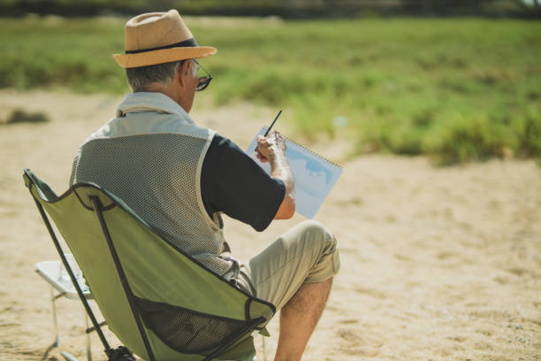 istock Senior men past retirement age relax and enjoy their hobbies on a sandy beach. 2168207623
