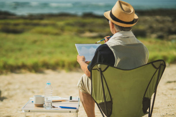 istock Senior men past retirement age relax and enjoy their hobbies on a sandy beach. 2168207629