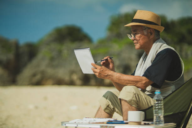 istock Senior men past retirement age relax and enjoy their hobbies on a sandy beach. 2168207635