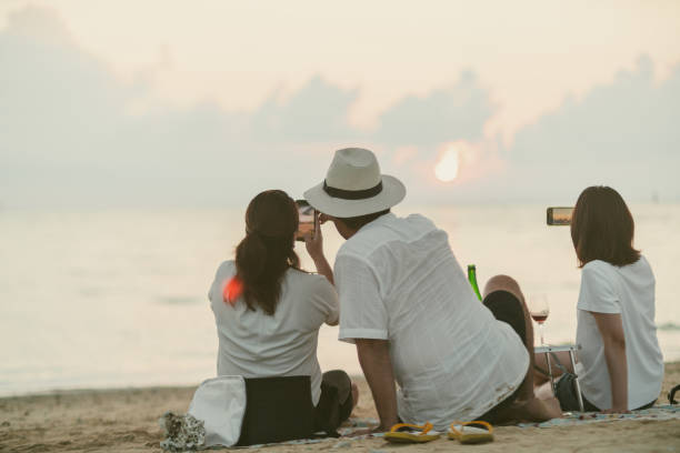 Young generation living in Asia spending time with friends and family at the beach