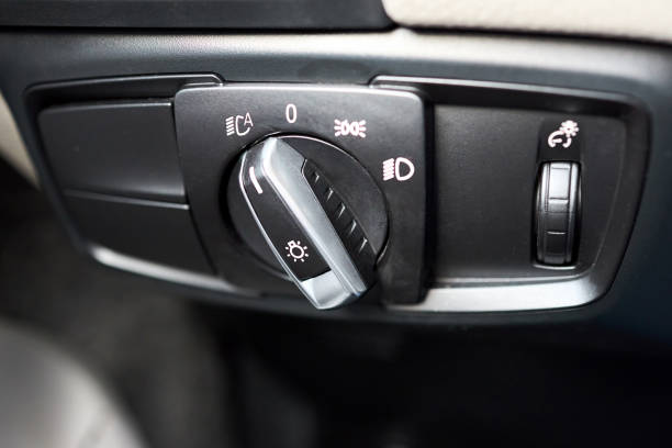 istock Car interior automotive detailing light switch control button on dashboard. Modern car headlight controls. 2168211748