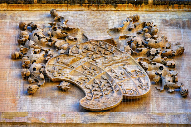 Architectural Decoration on the outside of a building at Florence in Tuscany, Italy. This appears to show a symbol of medieval Florence with a scroll attached.