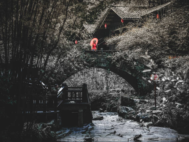 Yichang,china 4 april 2024 - red dress girl stand on the boat at Longjin stream,three gorge tribute scenic spot,Yichang