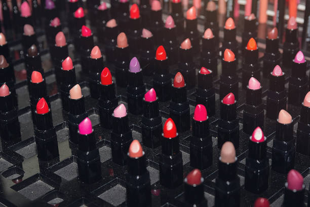 Array of vibrant lipsticks neatly displayed in a cosmetics store. Beauty industry