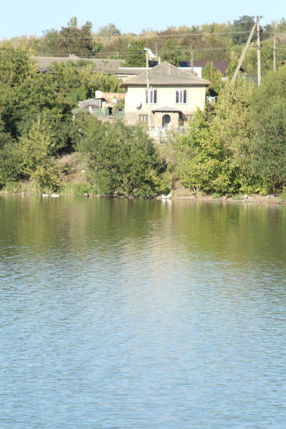 istock A house on a hill above a lake 2168223403