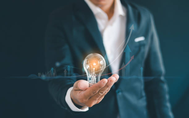 istock Businessman's hand holding a light bulb. Idea concept. Business growth. 2168224481