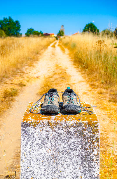 istock Hiking boots on milestone along Camino de Santiago. 2168225918