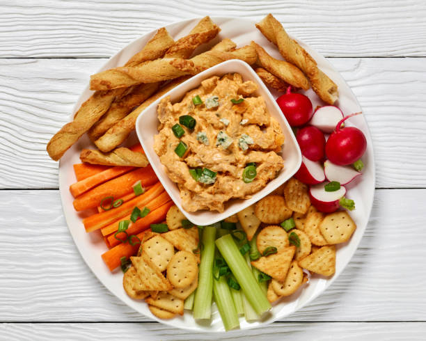 istock buffalo chicken dip with veggie and bread sticks 2168229851