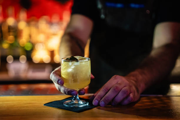 istock Close-up of a bartender serving a refreshing drink 2168238776