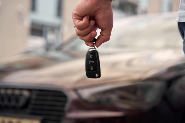 Car key on the wood table with sunlight reflection and copy space