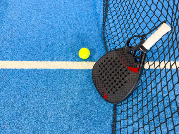 istock padel racket on a padel blue court with a ball 2168246240
