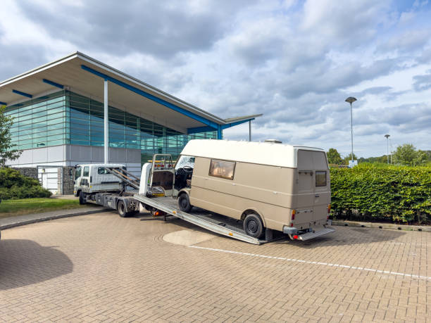 A tow truck collecting a broken down van