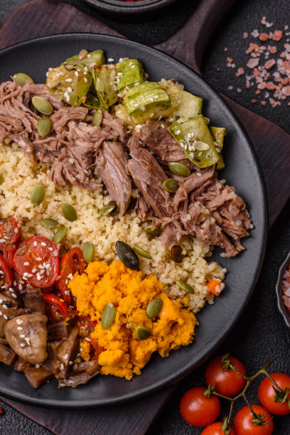 istock Bowl of food with beef, bulgur, tomatoes, mushrooms, zucchini 2168258607