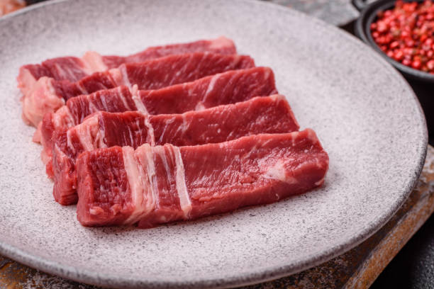 istock Fresh raw beef cut into slices with salt, spices 2168259314