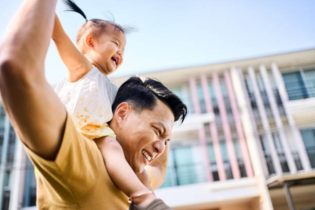 istock Father walking outside house with daughter on his shoulder 2168270257