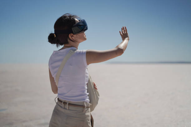 istock Beautiful young Asian female tourist using her virtual reality VR glasses, while exploring the Salt Lake in Konya Turkey, Turkiye. 2168273471