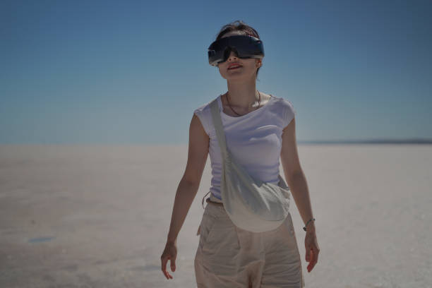 istock Beautiful young Asian female tourist using her virtual reality VR glasses, while exploring the Salt Lake in Konya Turkey, Turkiye. 2168273624