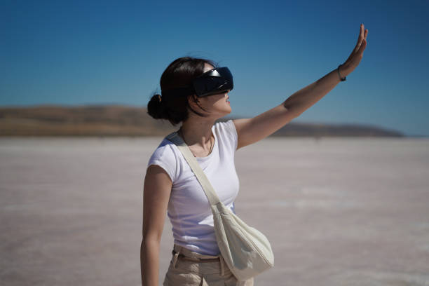 Beautiful young Asian female tourist using her virtual reality VR glasses, while exploring the Salt Lake in Konya Turkey, Turkiye.
