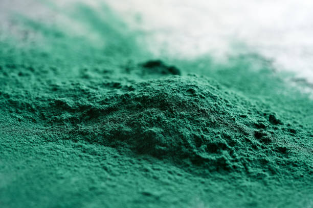 A heap of green spirulina algae powder, closeup